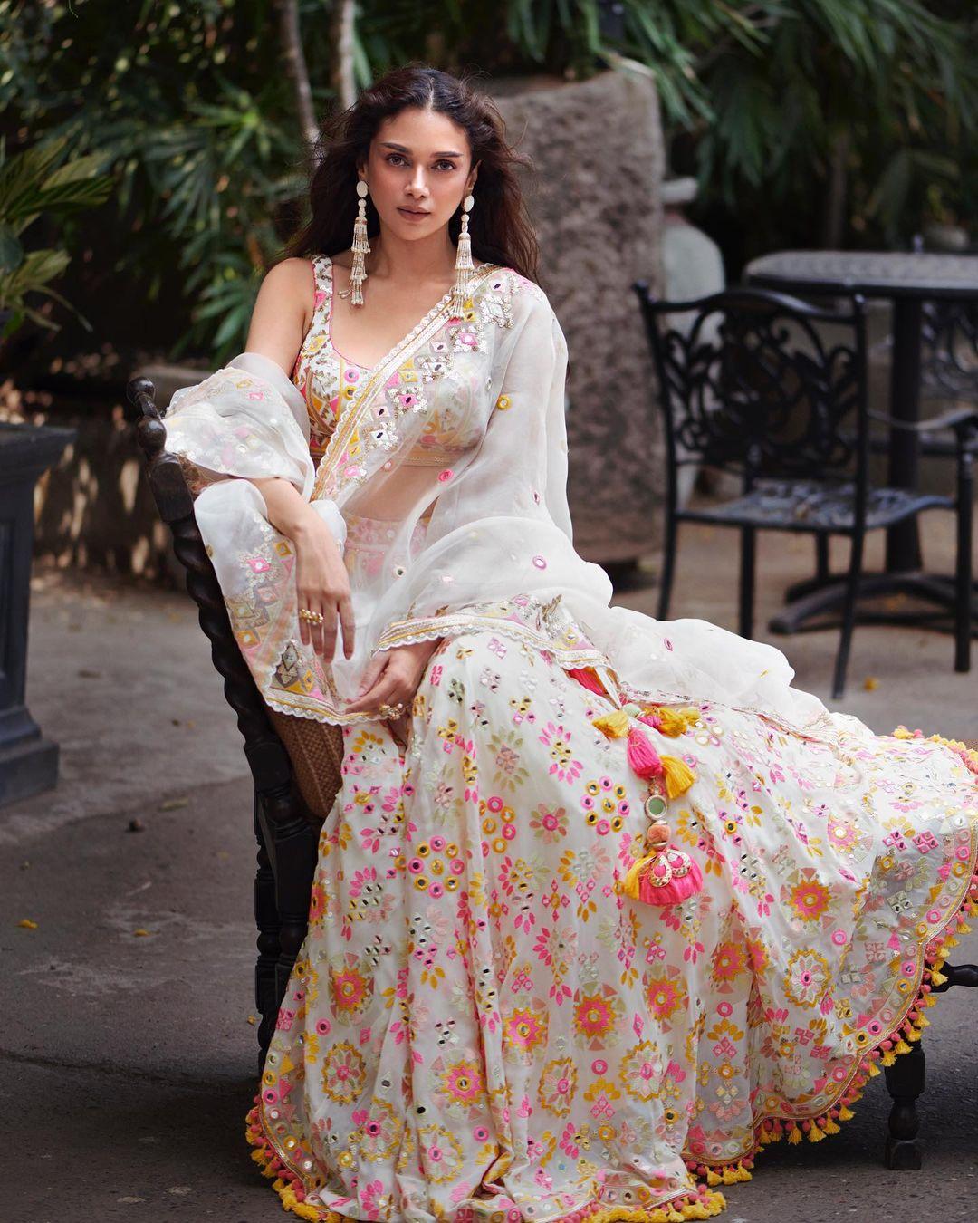 God save us from this beautiful diva. Aditi in this appearance wore a gorgeous white lehenga with yellow, pink, and orange designs on it. The actress' lehenga also featured mirror work on it